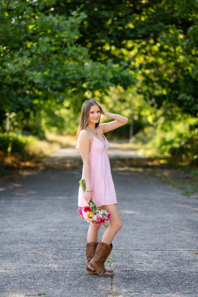 senior girl short pink dress with cowboy boots discovery park