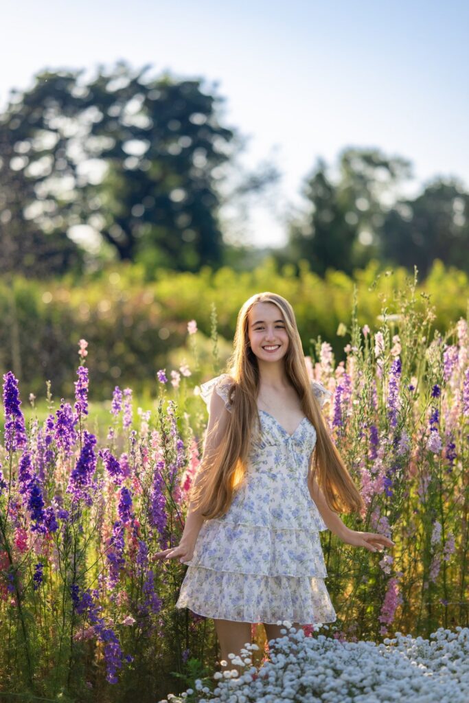 snohomish high school senior in flower field twirling