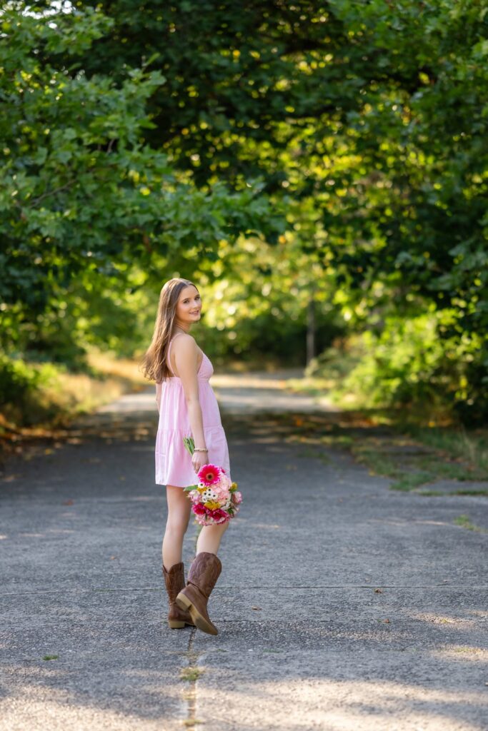 high school senior girl with bouquet in pink dress