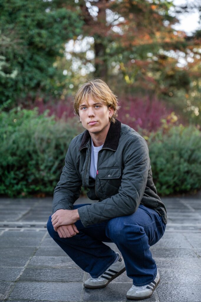 senior guy poses at bellevue botanical garden