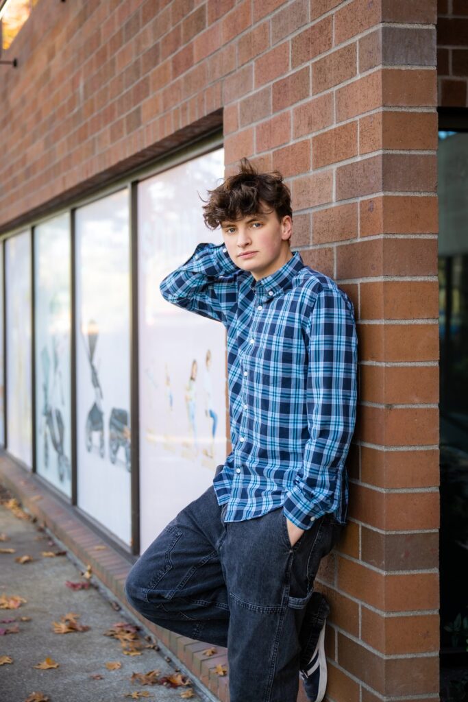 senior guy blue shirt brick building