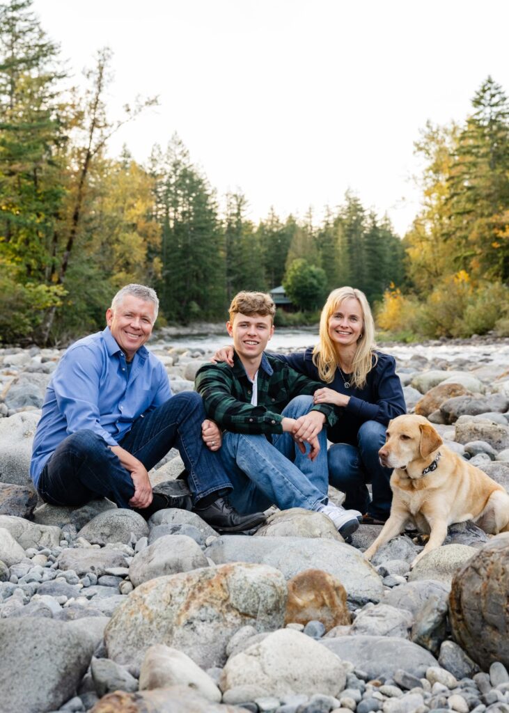 family and dog at river