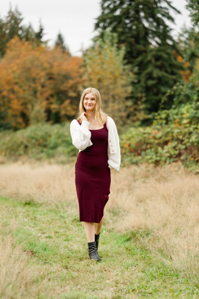 high school senior girl walks woodinville park in fall