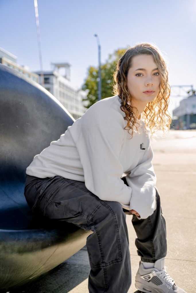 kirkland senior girl seated on street art in seattle