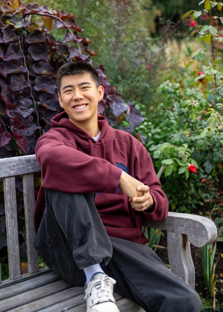 high school senior boy seated bellevue botanical garden