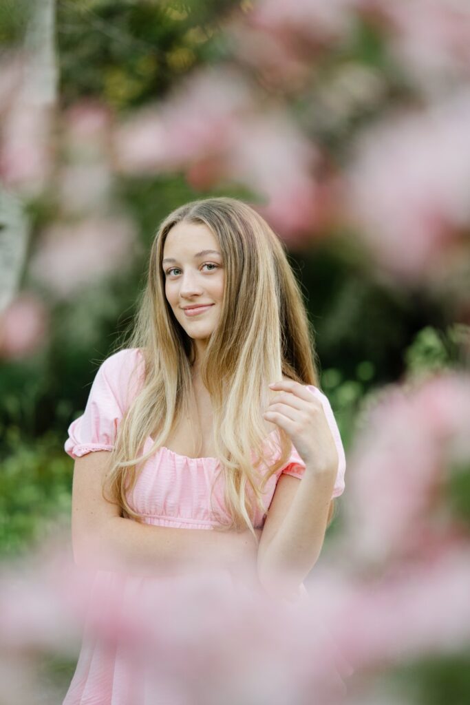 senior girl in pink dress at bellevue botanical garden in spring