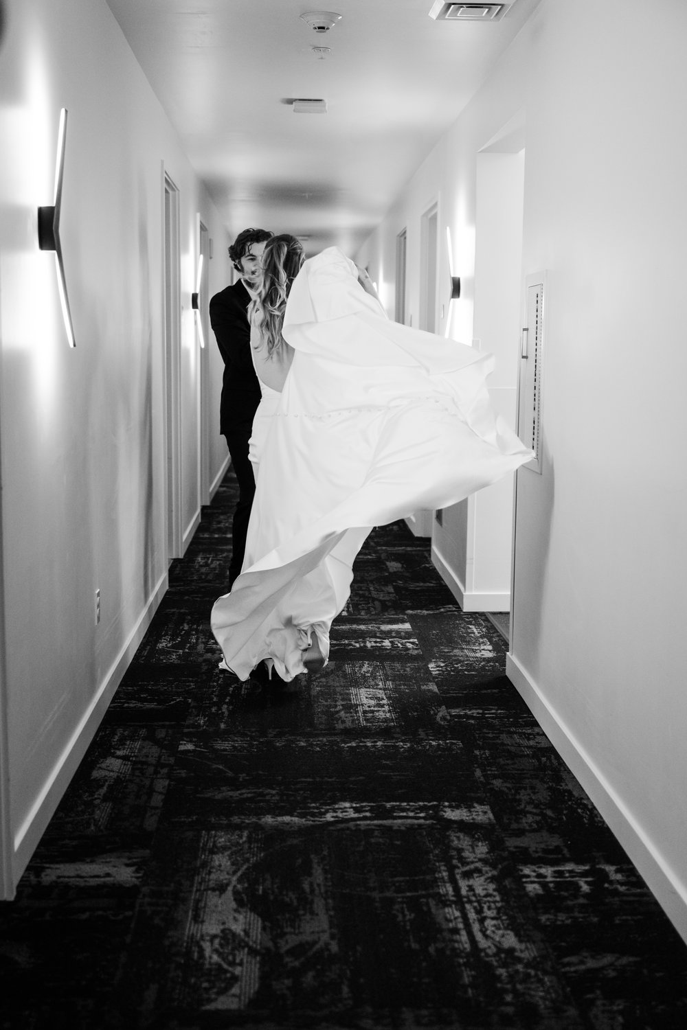 wedding couple playful running at hotel